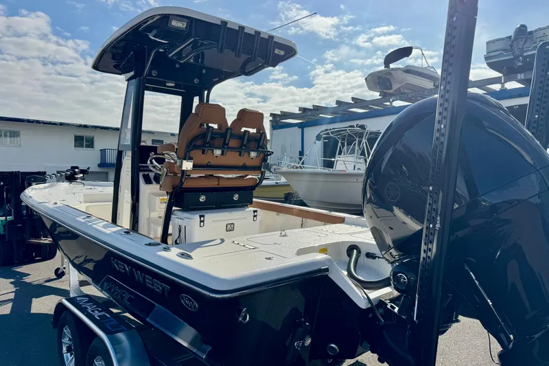 Slide: The Image of 2026 Key West 230 Bay Reef boat with dual seats and powerful outboard motor. - 12