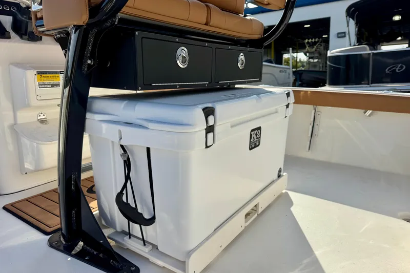 Slide: The Image of 2026 Key West 230 Bay Reef boat interior with cooler and storage compartment. - 15