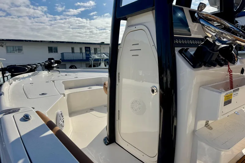 Slide: The Image of 2026 Key West 230 Bay Reef boat interior with steering console and seating area. - 18