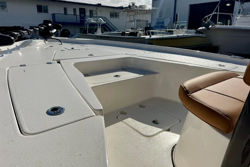 Slide: The Image of 2026 Key West 230 Bay Reef boat interior with seating and storage compartments. - 20