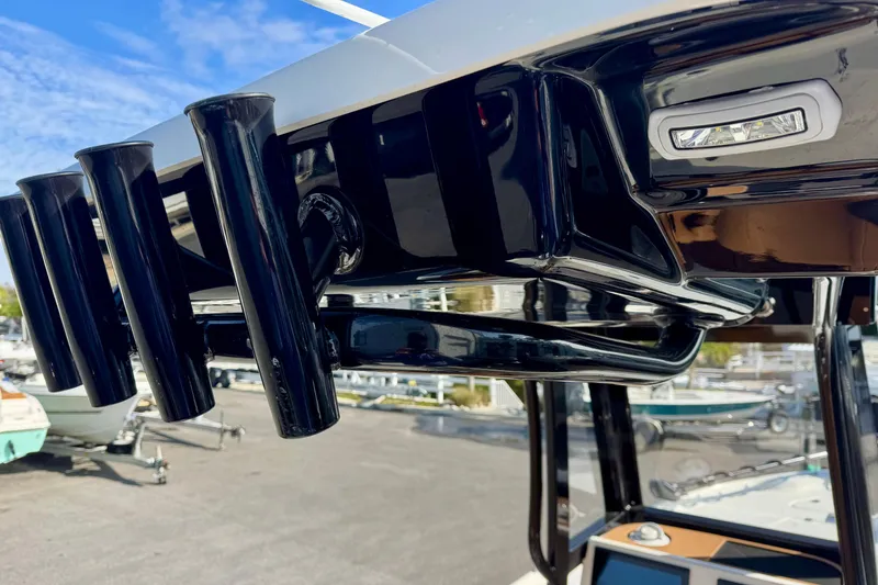 Slide: The Image of 2026 Key West 230 Bay Reef boat with black rod holders and sleek design. - 21