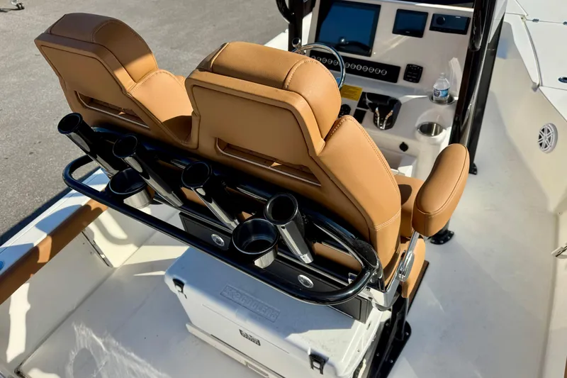 Slide: The Image of 2026 Key West 230 Bay Reef boat interior with tan seats and rod holders. - 22