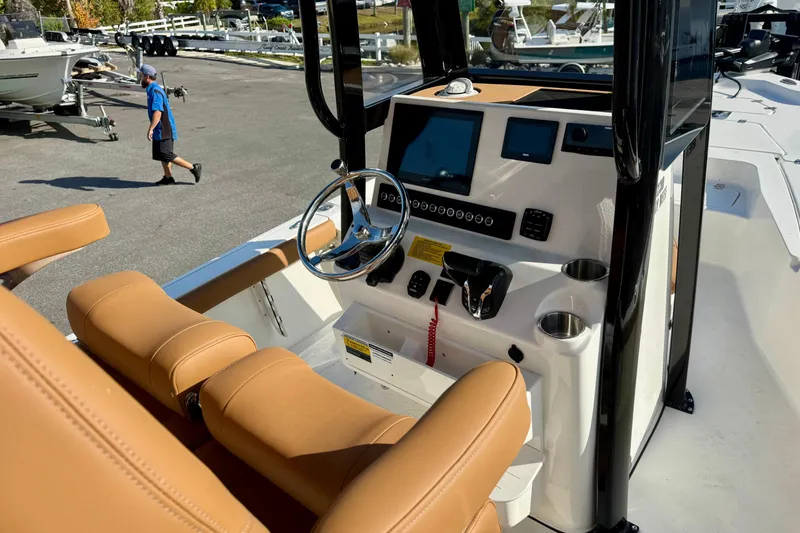 Slide: The Image of Interior of 2026 Key West 230 Bay Reef boat with tan seating and modern controls. - 23
