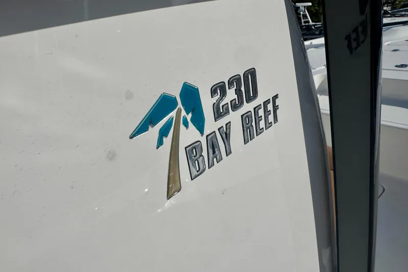 Slide: The Image of 2026 Key West 230 Bay Reef boat logo on white surface. - 27