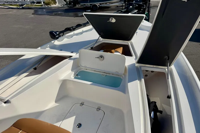 Slide: The Image of 2026 Key West 230 Bay Reef boat interior with open storage compartments. - 28