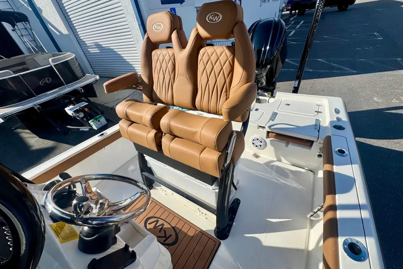 Slide: The Image of 2026 Key West 230 Bay Reef boat with luxurious tan seating and modern steering wheel. - 35