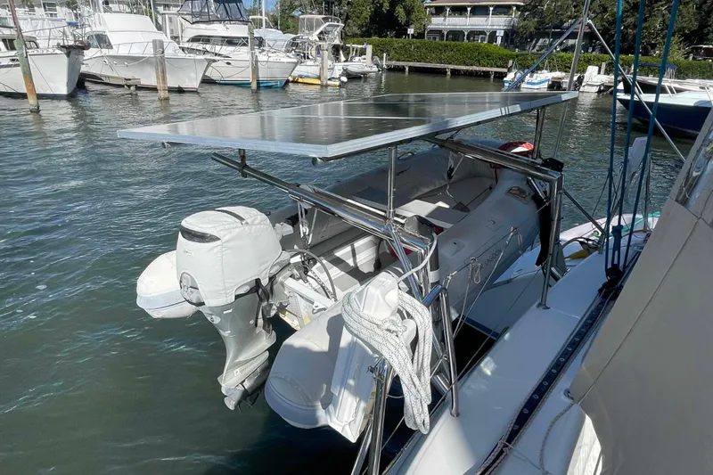 Slide: The Image of Catamaran Lagoon 380 S2 (2012) with solar panel and dinghy at marina. - 101
