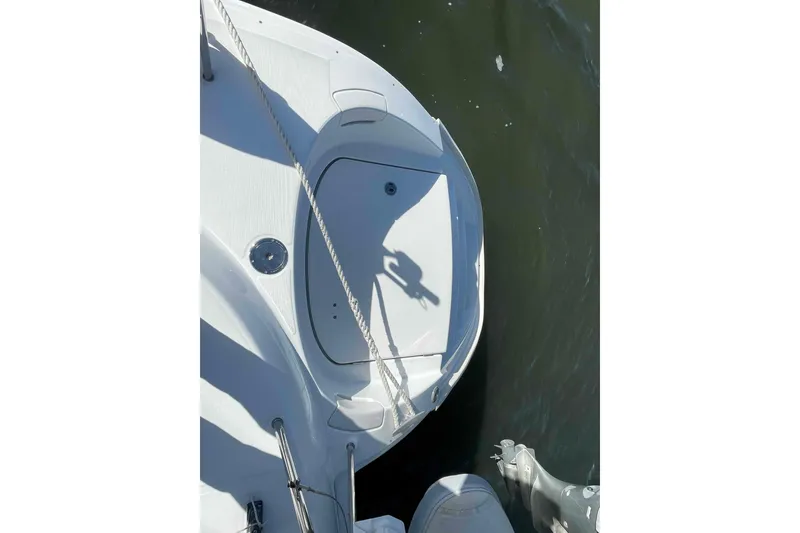 Slide: The Image of Top view of a 2012 Lagoon 380 S2 catamaran deck with water in the background. - 103