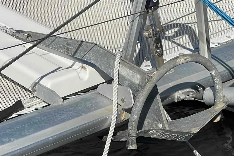 Slide: The Image of Anchor detail on 2012 Lagoon 380 S2 catamaran, featuring metal and rope components. - 106
