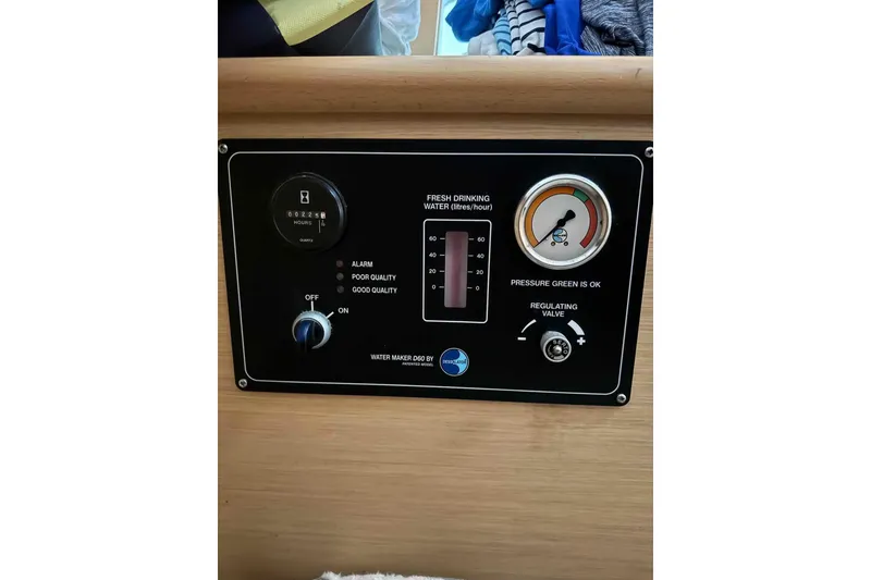 Slide: The Image of Interior of 2012 Lagoon 380 S2 catamaran with cozy seating and modern kitchen amenities. - 11