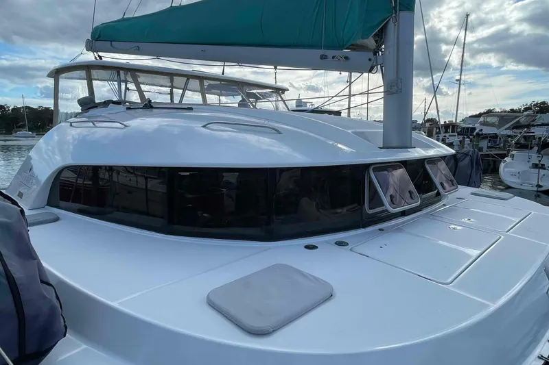 Slide: The Image of Interior of 2012 Lagoon 380 S2 yacht with window, control panel, and nautical-themed bedding. - 43