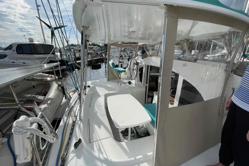 Slide: The Image of Lagoon 380 S2 catamaran, 2012 model, docked in a marina with other boats. - 68