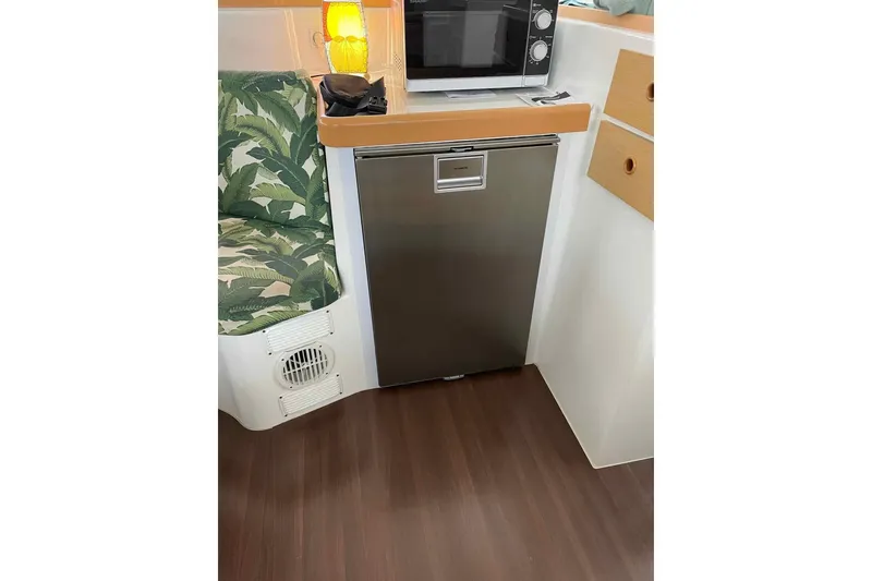 Slide: The Image of Cozy bedroom interior of 2012 Lagoon 380 S2 catamaran with blue bedding and decorative pillows. - 8