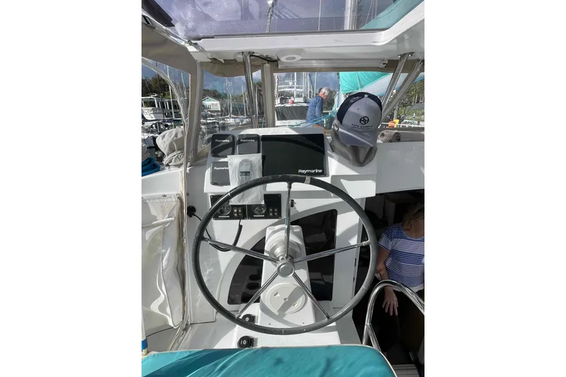 Slide: The Image of Cockpit of 2012 Lagoon 380 S2 catamaran with steering wheel and navigation equipment. - 85