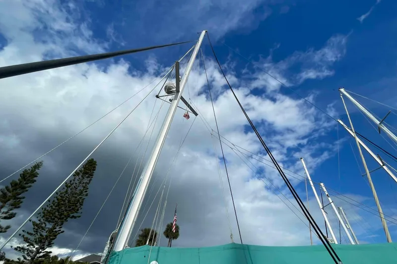 Slide: The Image of Mast of 2012 Lagoon 380 S2 sailboat against a partly cloudy sky. - 89
