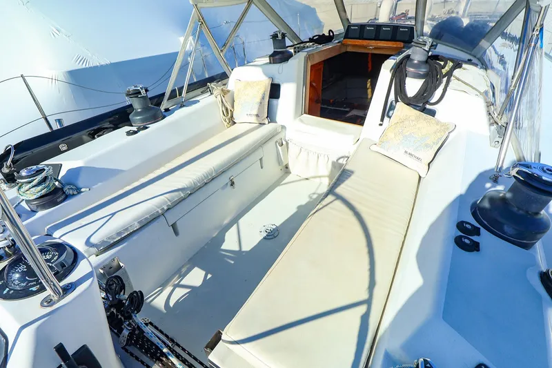 Slide: The Image of 2004 J Boats J/46 sailboat cockpit with cushioned seating and nautical equipment. - 11