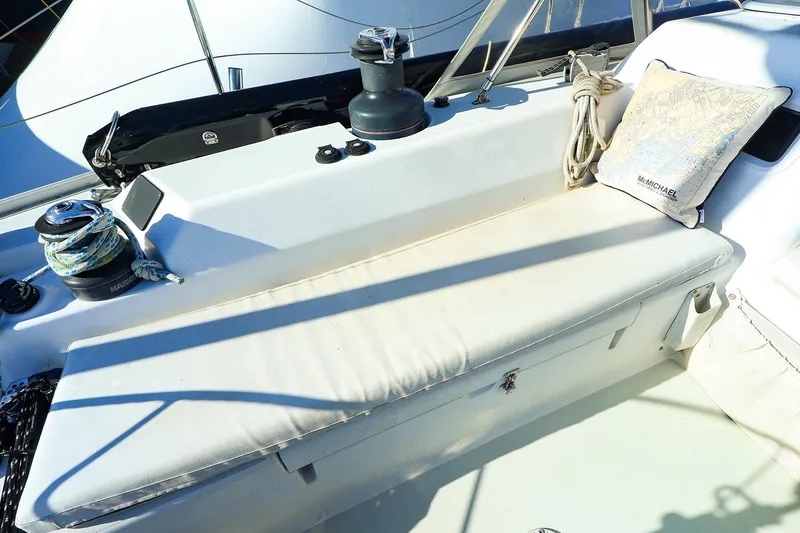 Slide: The Image of 2004 J Boats J/46 sailboat cockpit with winch, ropes, and cushion. - 16