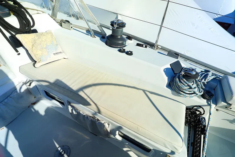 Slide: The Image of 2004 J Boats J/46 sailboat cockpit with winch, ropes, and nautical map pillow. - 17