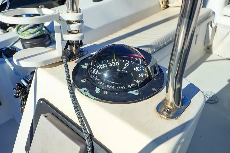 Slide: The Image of Compass on 2004 J Boats J/46 sailboat deck, surrounded by nautical equipment. - 18