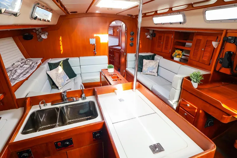 Slide: The Image of Luxurious 2004 J Boats J/46 yacht interior with elegant wood finish and cozy seating area. - 22