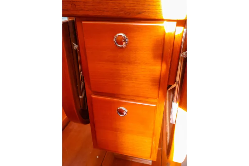 Slide: The Image of Wooden cabinetry with chrome handles inside a 2004 J Boats J/46 sailboat. - 33