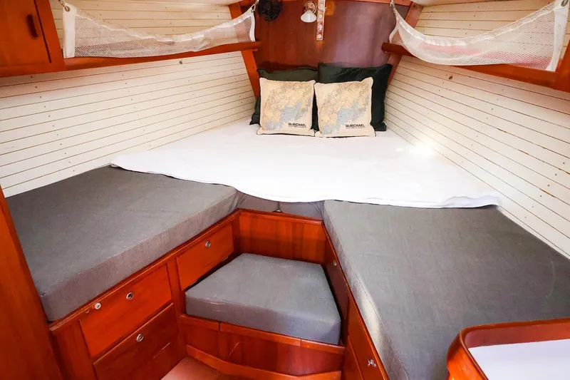 Slide: The Image of 2004 J Boats J/46 cabin interior with cozy bedding and wooden storage. - 35