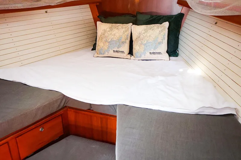 Slide: The Image of Cozy cabin interior of 2004 J Boats J/46 with nautical-themed pillows and wooden accents. - 36
