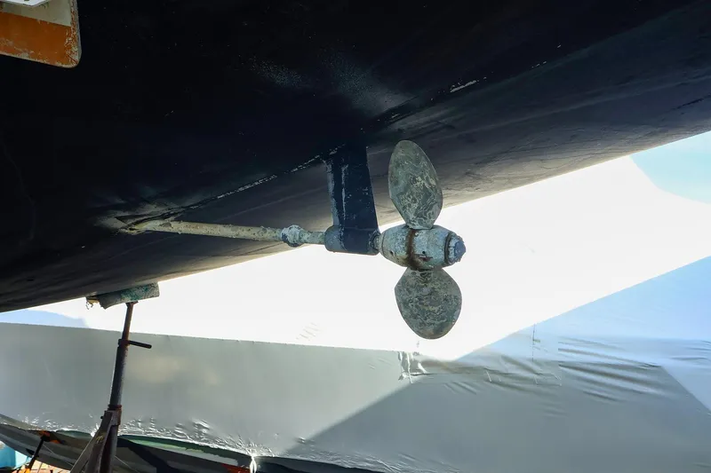 Slide: The Image of Propeller of 2004 J Boats J/46 sailboat, under maintenance, with visible wear. - 6