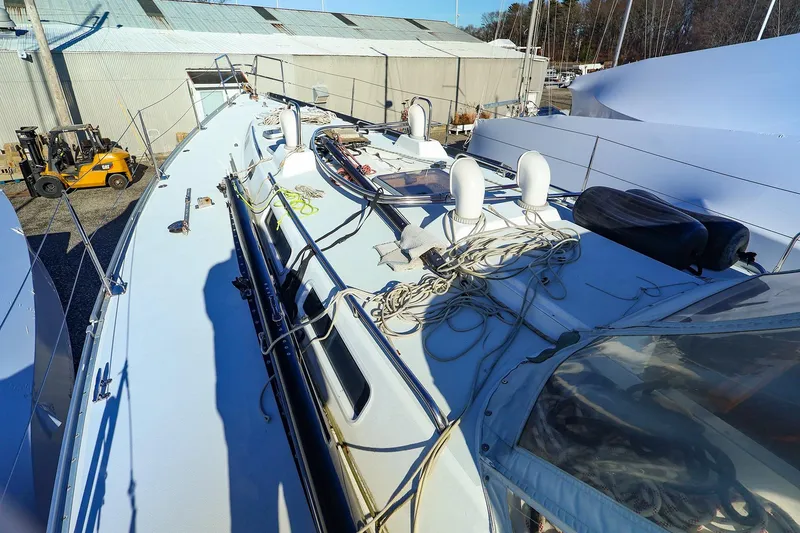 Slide: The Image of 2004 J Boats J/46 sailboat deck with ropes and equipment in a marina setting. - 7