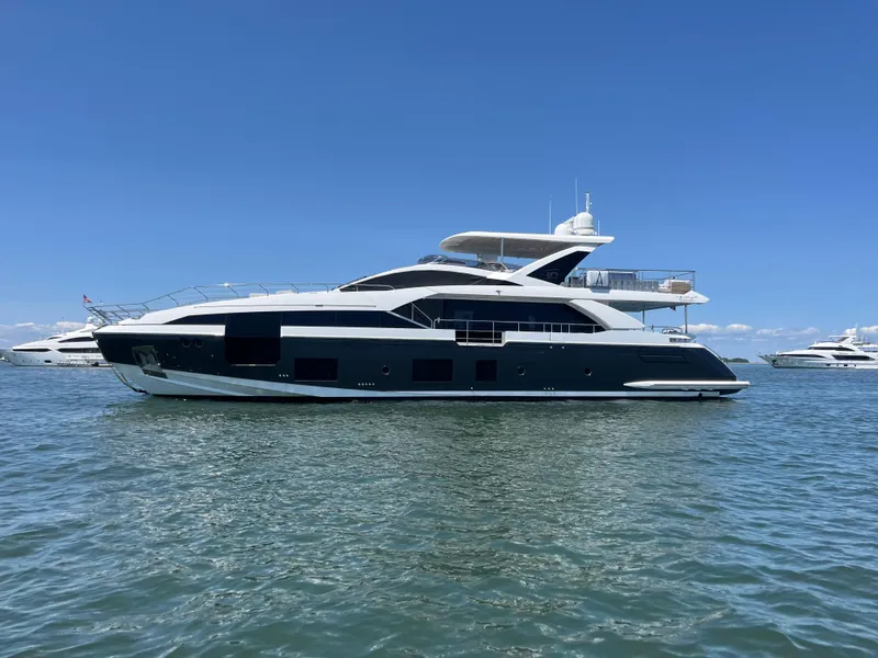 The Image of 2019 Azimut Grande 27M yacht on calm water under clear blue sky. - 1