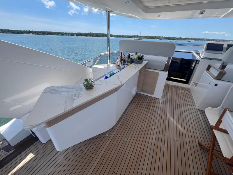 Slide: The Image of Luxurious Azimut Grande 27M yacht deck with sleek bar and scenic ocean view. - 12