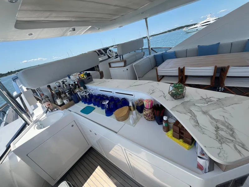 Slide: The Image of Luxurious 2019 Azimut Grande 27M yacht with elegant outdoor bar and seating area. - 13