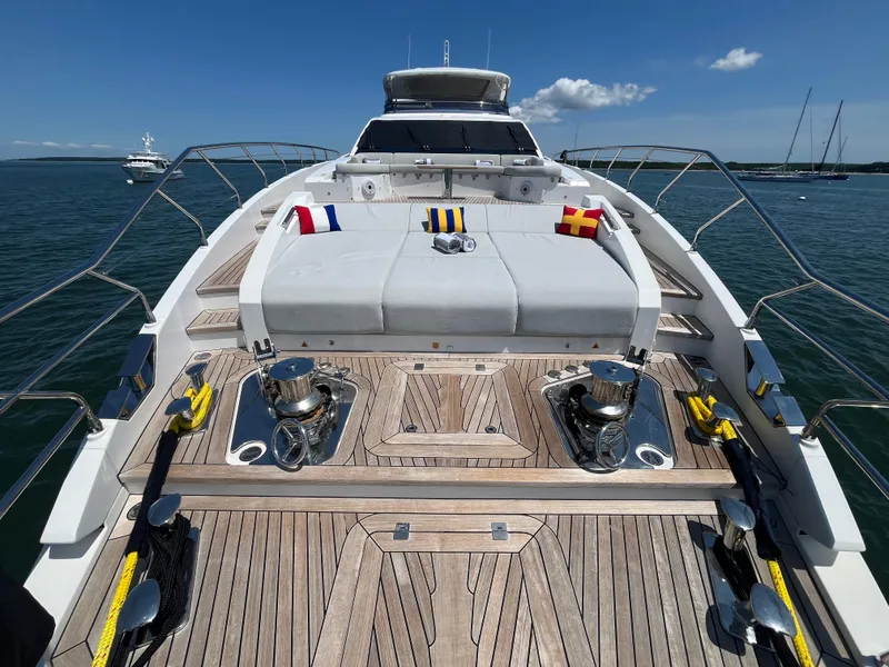 Slide: The Image of Luxurious 2019 Azimut Grande 27M yacht deck with plush seating and nautical flags. - 17