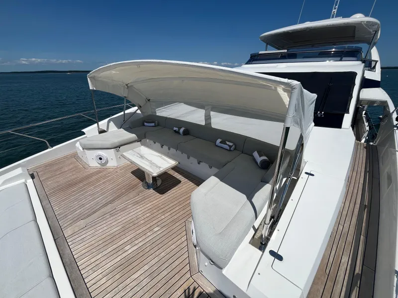 Slide: The Image of Azimut Grande 27M 2019 yacht deck with shaded seating area and ocean view. - 22