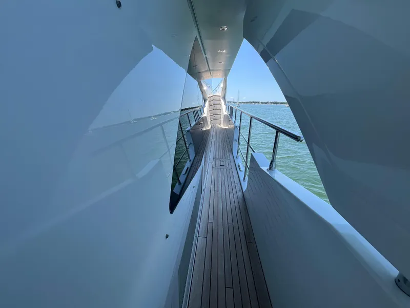 Slide: The Image of Side deck view of 2019 Azimut Grande 27M yacht with sleek design and ocean backdrop. - 26