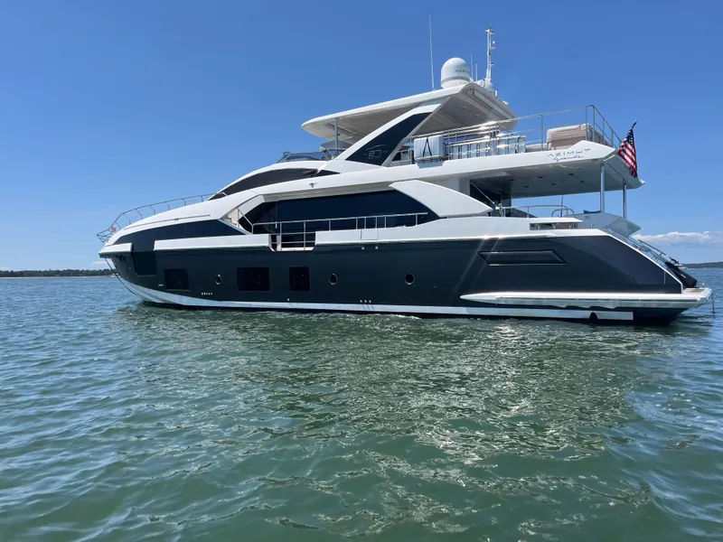 Slide: The Image of Luxurious 2019 Azimut Grande 27M yacht on calm waters under a clear blue sky. - 3