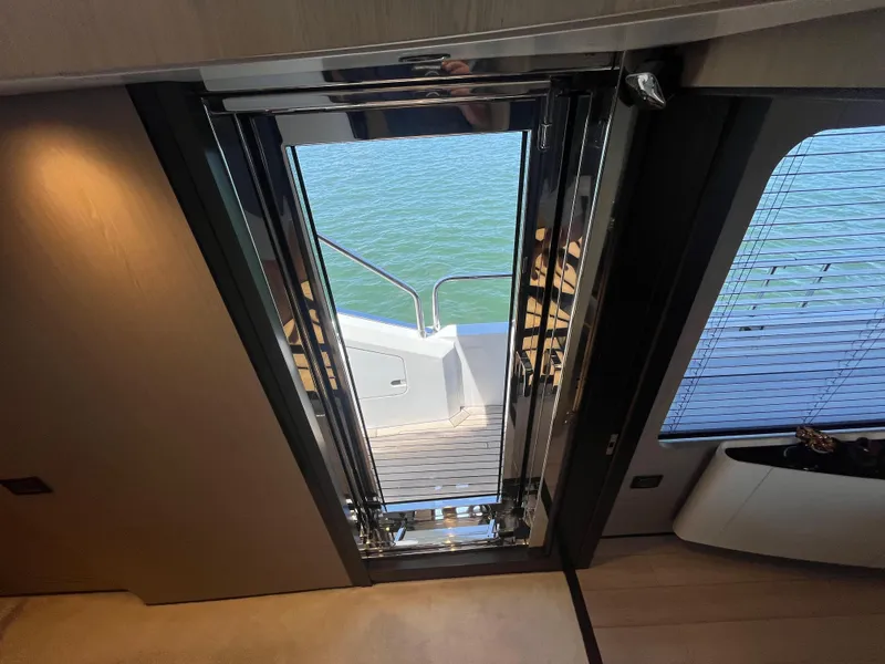 Slide: The Image of Interior view of 2019 Azimut Grande 27M yacht, showcasing sleek doorway to deck. - 38