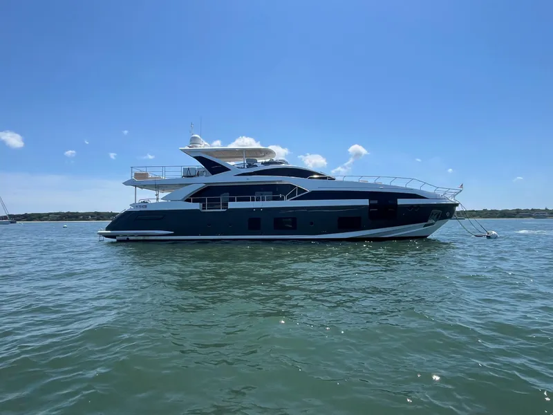 Slide: The Image of 2019 Azimut Grande 27M yacht on calm water under clear blue sky. - 4