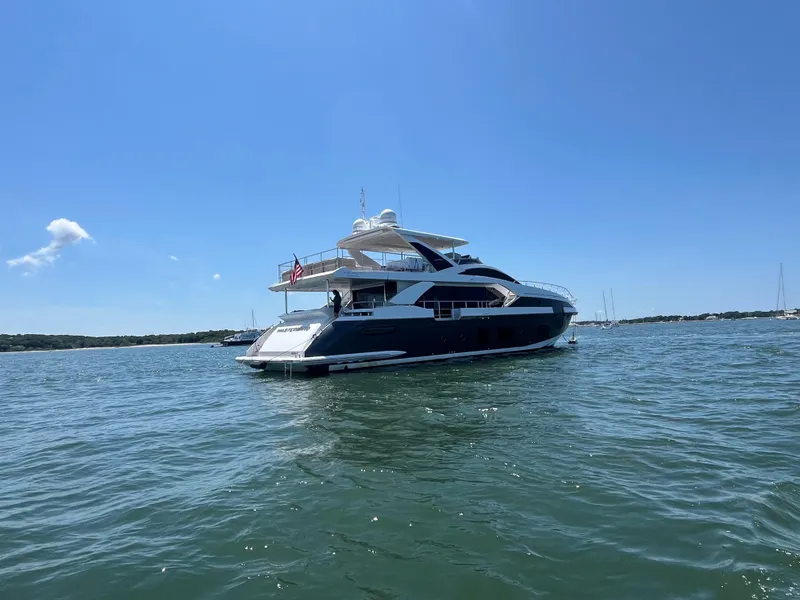 Slide: The Image of 2019 Azimut Grande 27M yacht on calm water under clear blue sky. - 5