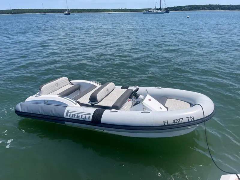 Slide: The Image of Inflatable boat on water, labeled "Pirelli," near Azimut Grande 27M yacht, 2019 model. - 8