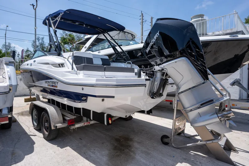Slide: The Image of 2024 Monterey M-45 boat on trailer with Mercury outboard engine. - 2