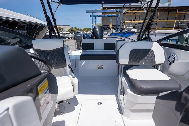 Slide: The Image of 2024 Monterey M-45 boat interior with modern seating and steering wheel, docked outdoors. - 21
