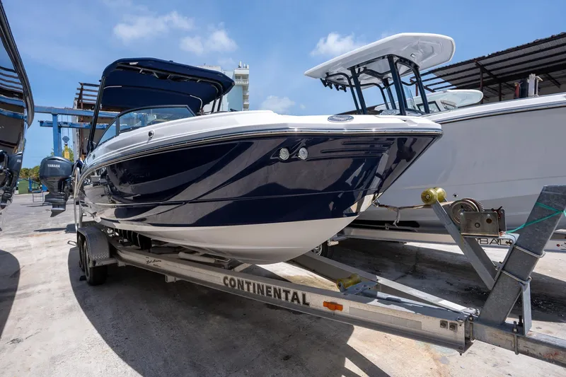 Slide: The Image of 2024 Monterey M-45 boat on trailer, dockside under clear blue sky. - 5