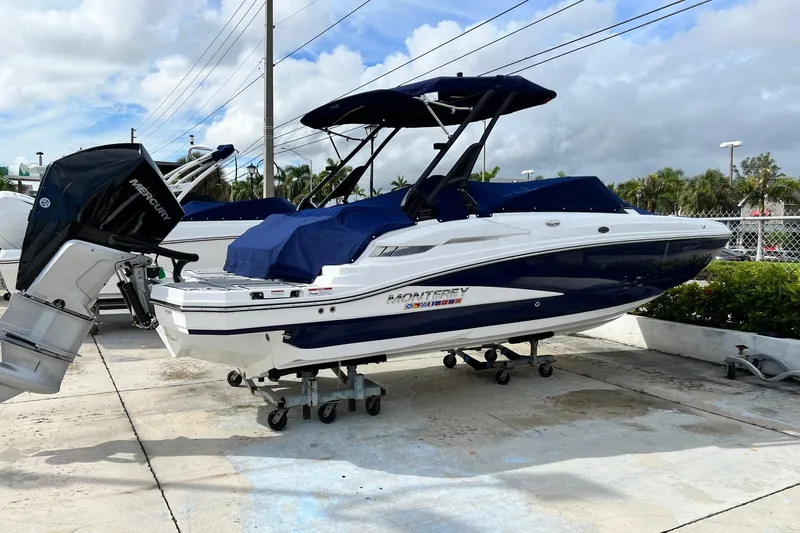 Slide: The Image of 2024 Monterey M-45 boat with Mercury engine, parked outdoors on a sunny day. - 6