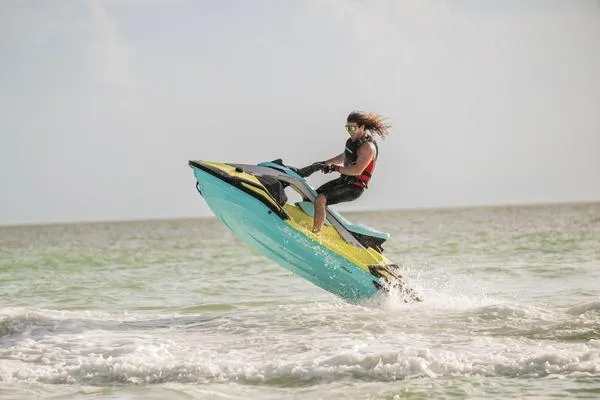 Slide: The Image of 2025 Yamaha WaveRunner JetBlaster PRO 2-Up performing a jump on the ocean waves. - 7