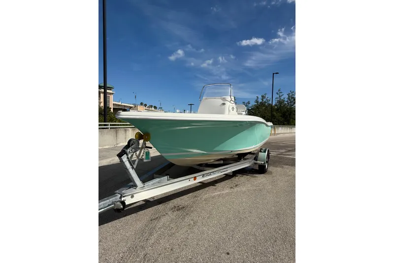 Slide: The Image of 2020 Tidewater 198 CC Adventure boat on trailer under clear blue sky. - 3