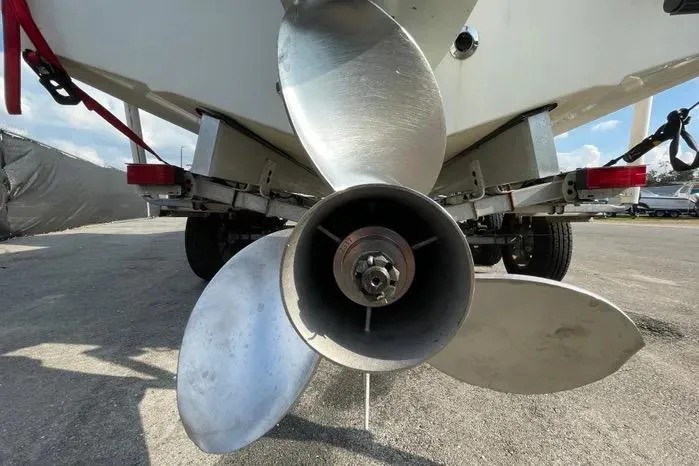 Slide: The Image of 2004 Kenner Fishmaster Travis Edition 220 boat, black and white hull, outdoor display. - 10