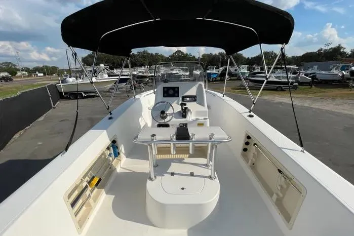 Slide: The Image of 2004 Kenner Fishmaster Travis Edition 220 boat deck with storage hatch. - 15