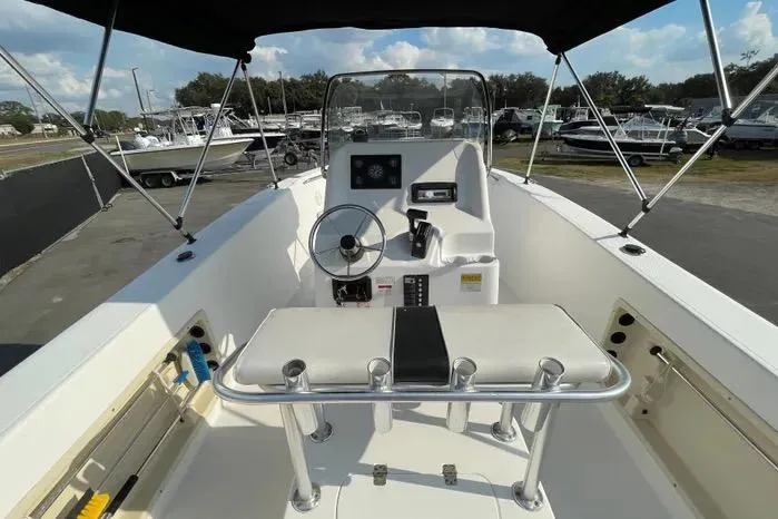 Slide: The Image of 2004 Kenner Fishmaster Travis Edition 220 boat interior with steering wheel and seating. - 19