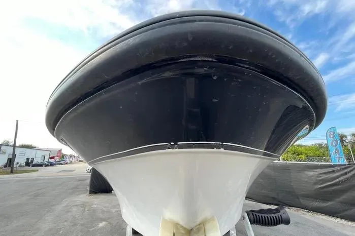 Slide: The Image of 2004 Kenner Fishmaster Travis Edition 220 boat on trailer, under a cloudy sky. - 2